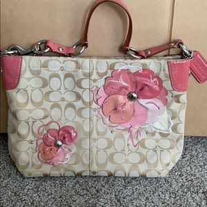 Cream Coach purse with coral leather floral accent